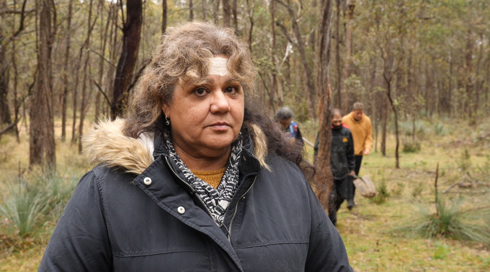 An indigenous woman looking at the camera