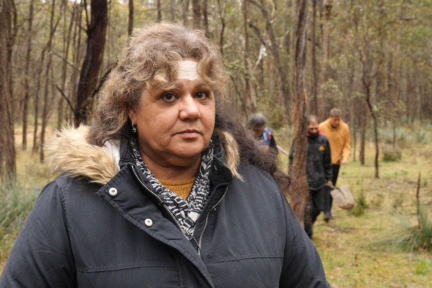 An indigenous woman looking at the camera