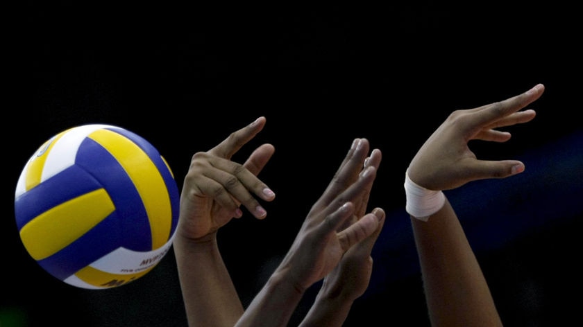 Yanelis Santos Allegne and Nancy Carrillo de la Paz jump to block a spike