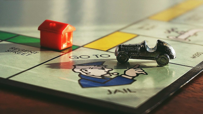 House and car on monopoly board game
