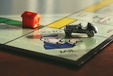 House and car on monopoly board game