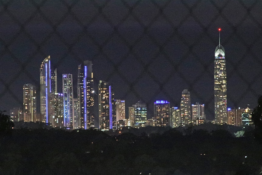 The Surfers Paradise skyline behind a chain-link fence