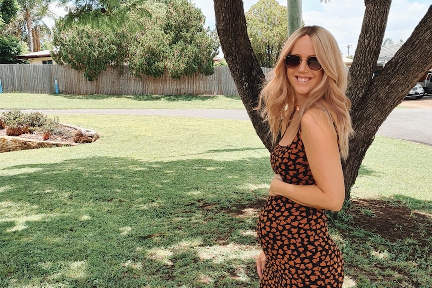 Kellie Scott holding her pregnancy bump