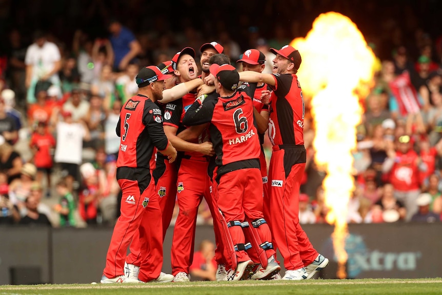 Renegades players hug each other in a huddle as they celebrate winning the Big Bash League final.