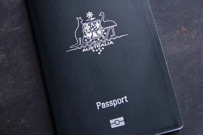 The blue cover of an Australian passport with the Commonwealth Coat of Arms and the words 'Australia' and 'passport' in silver.