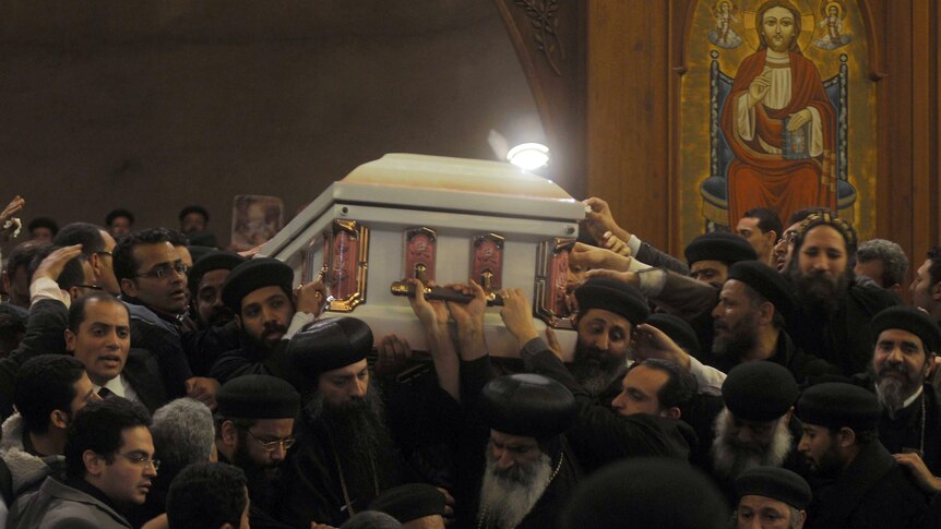 Pallbearers carry the coffin of Coptic Pope Shenouda III out of Saint Mark's cathedral.