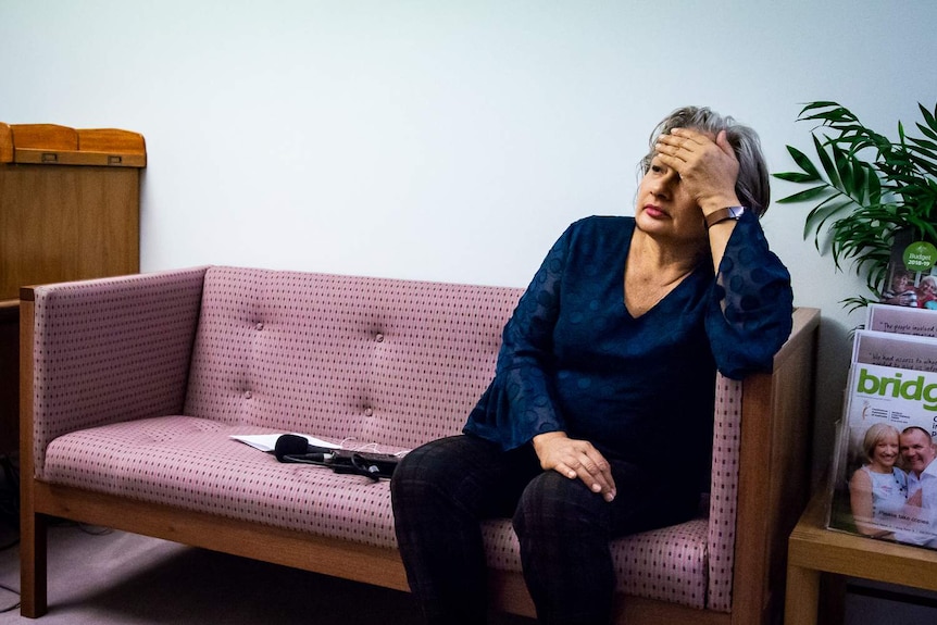 Jill Emberson is waiting on a couch outside Greg Hunt's office in Canberra.