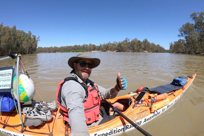 Marc Nieuwenhuys in his kayak rigged out with his equipment on the River Murray.