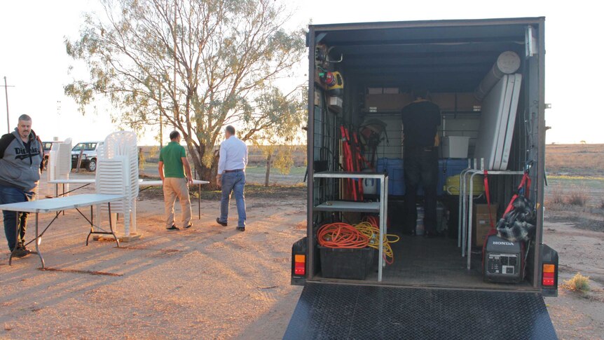 View into the back of a trailer with lots of items inside.