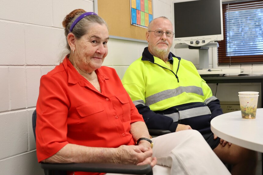 A vision impaired woman and man sit side-by-side