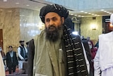 Mullah Abdul Ghani Baradar wearing Afghan attire.