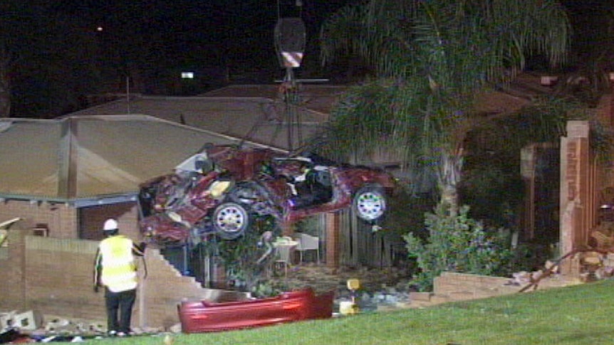 Crane lifts crumpled wreck of crashed car from Thornlie house