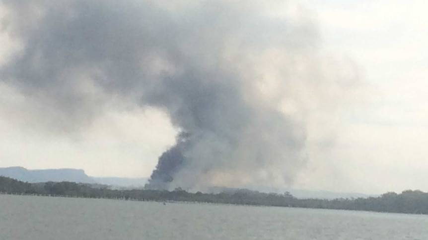 Looking across the Hastings River at bushfire smoke