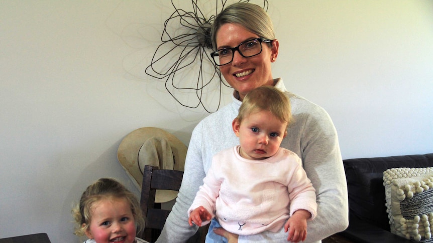 Bourke mother Sarah Barton holds her daughter Hattie on her hip next to her toddler, Camilla.