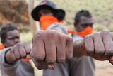 Aboriginal boys show their fists at NT Corrections bootcamp.