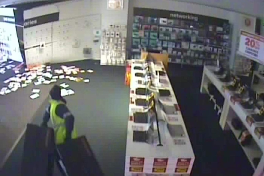CCTV footage shows two men in a store.
