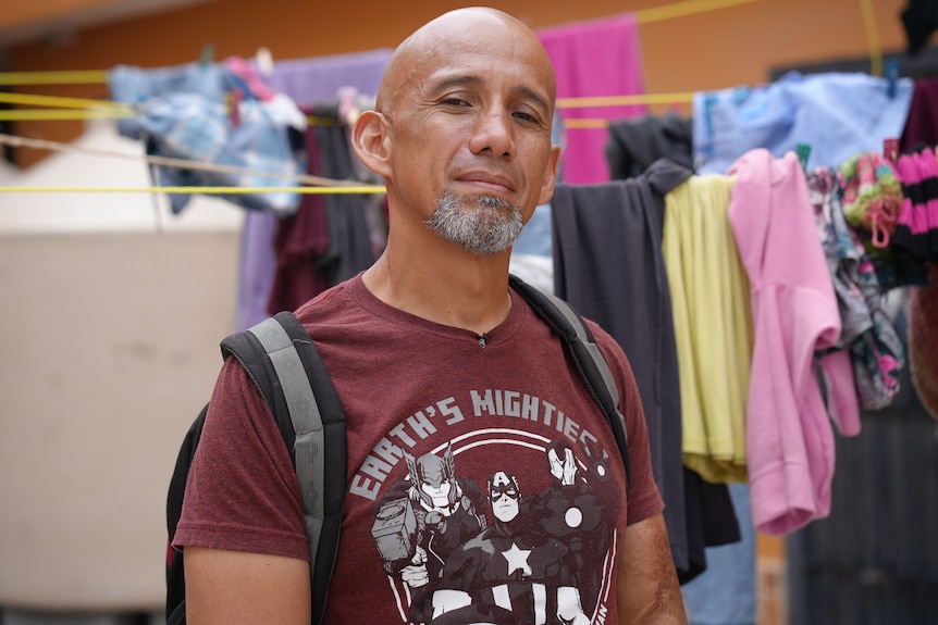 A man wearing a purple t-shirt.