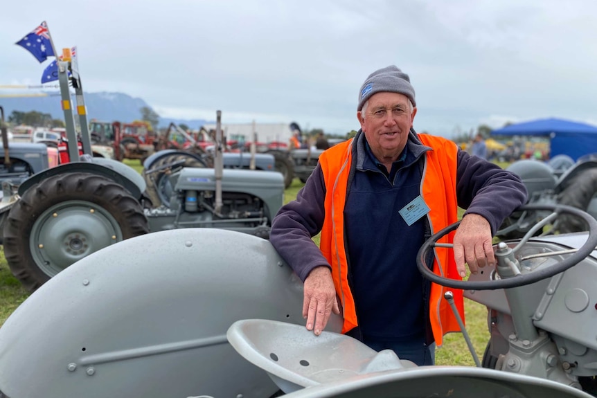 Sassafras farmer Lloyd Marshall leans upon one of his tractors.