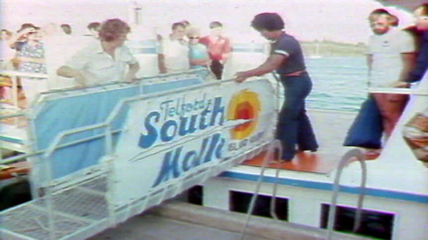 A ferry arrives at South Molle Island in a TV still from 1986.