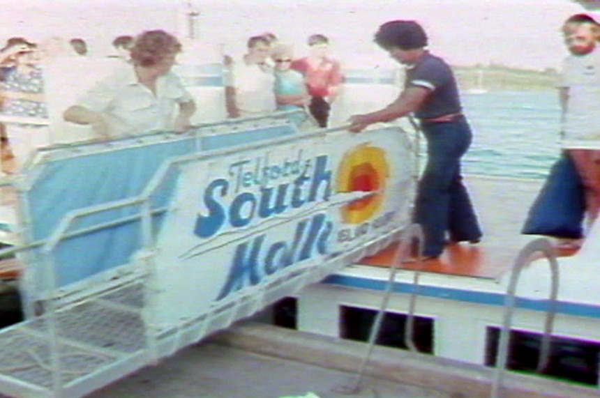 A ferry arrives at South Molle Island in a TV still from 1986.