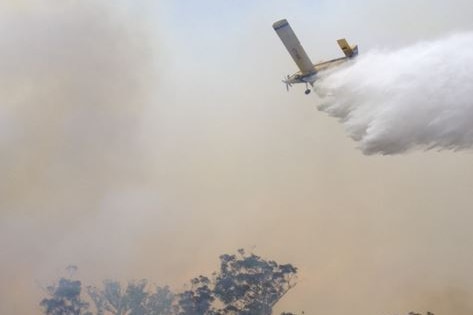 A waterbombing plane drops a load on Tasmanian bushfires 2016.