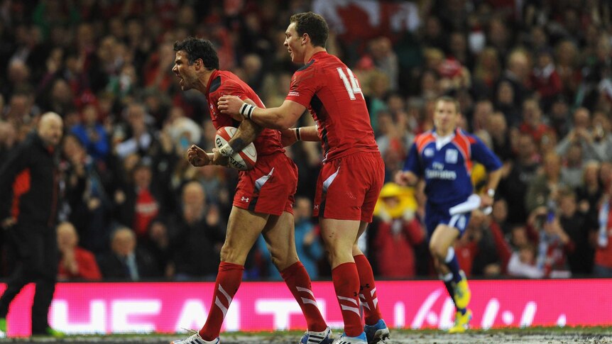 On top ... Mike Phillips (L) and George North celebrate a Welsh try