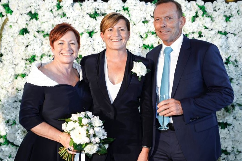 Former prime minister Tony Abbott poses with his sister Christine and her wife Virginia.