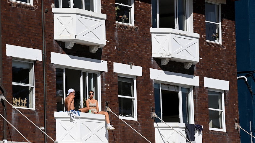 couple sit on balcony