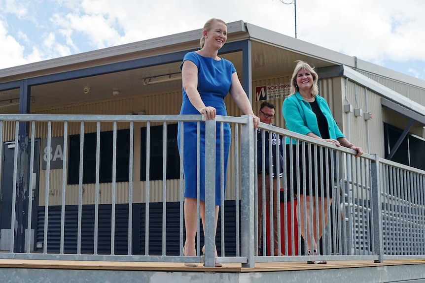 Nicole Manison and Eva Lawler are at Darwin Middle School smiling. They are on a small balcony and are looking slightly down.