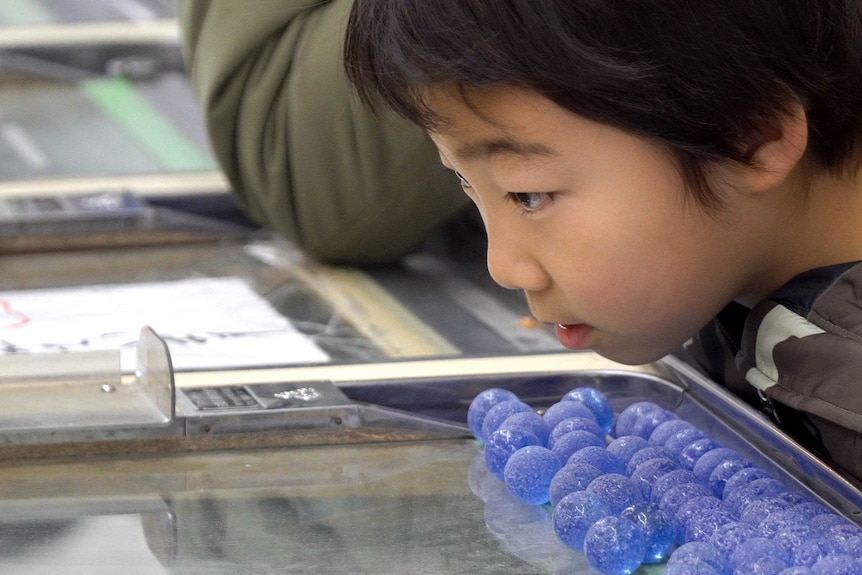 A child concentrates hard while playing smart ball.
