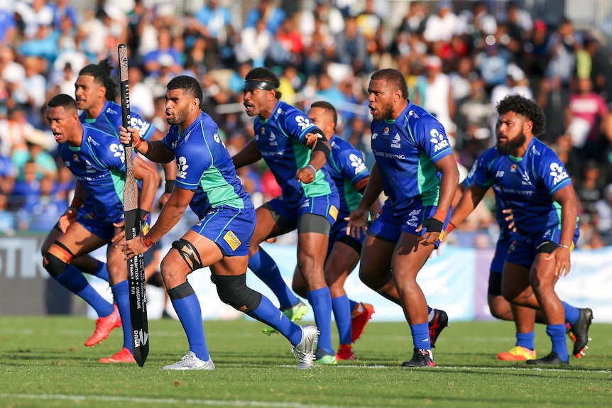 A group of Fijian rugby players perform a war dance before a match