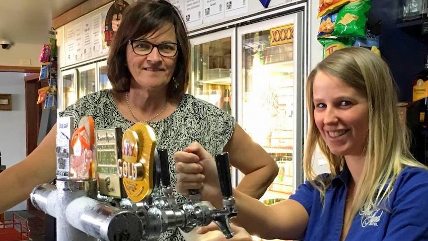 Clermont publican Leanne Appleton helps a staff member pull a beer.