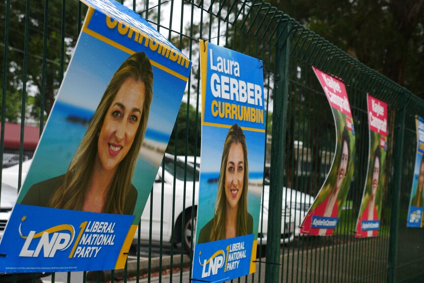 Signs with political candidates on them on a fence
