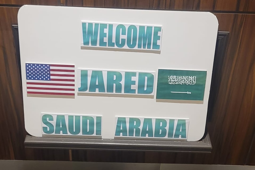A sign reading 'Welcome Jared Saudi Arabia'.
