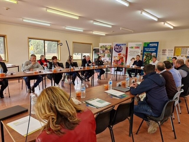 People sitting at tables discussing the future of the vegetable industry in Tasmania