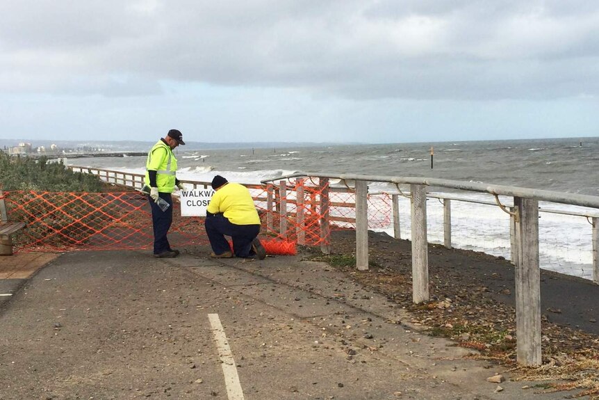 Charles Sturt Council staff close walkways to the beach after storm damage at West Beach
