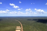 a road running through scrub, taken from a helicopter