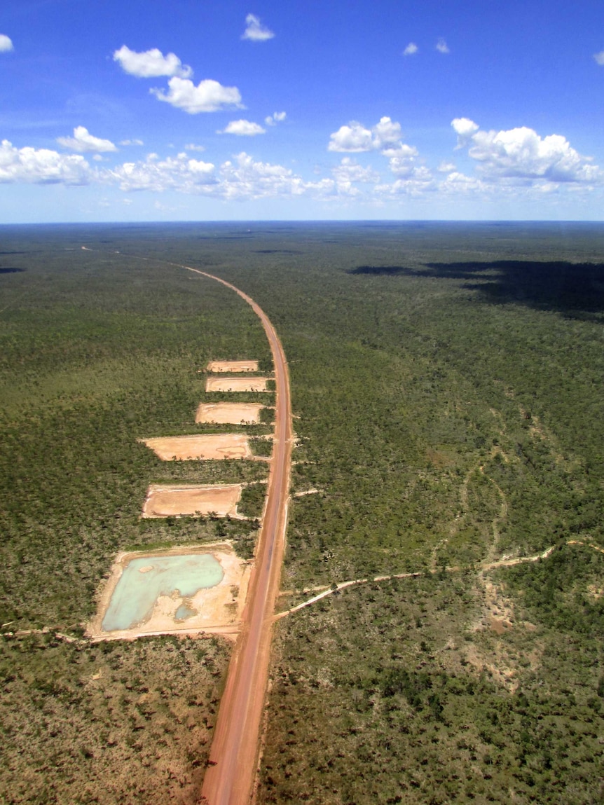 a road running through scrub, taken from a helicopter