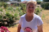 A woman wearing a t-shirt that says toxic soil is not welcome in Bacchus Marsh.