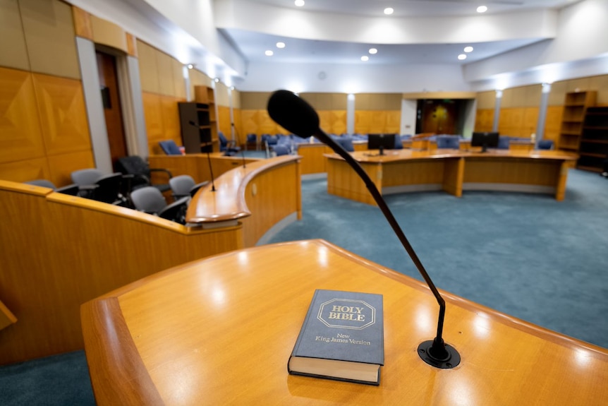 A view of a court room with a microphone in the foreground.