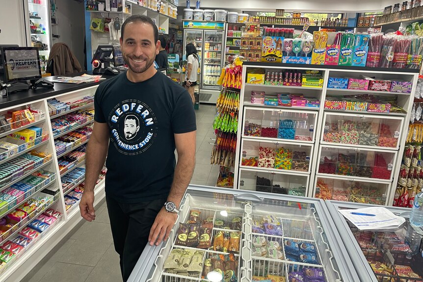 A man stands in a convenience store. 