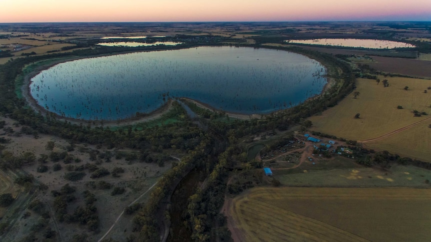 aerial view of a beautiful marshland lake with a small farm near it
