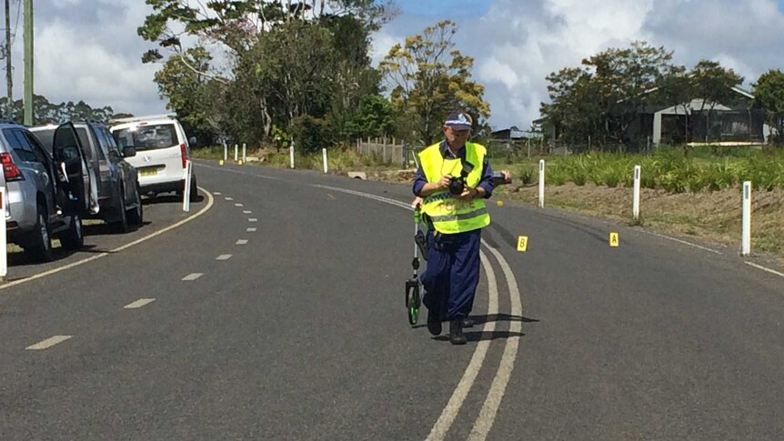 Police mark out skid marks at the scene of the fatality at Boatharbour.