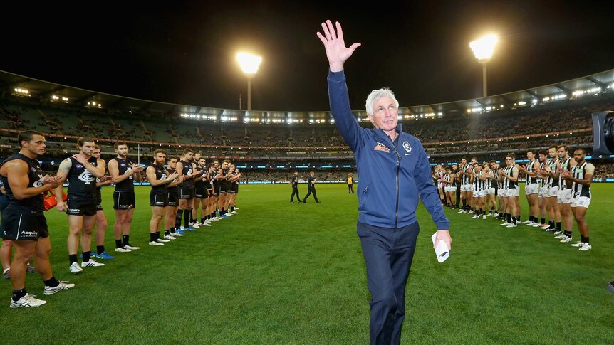 Guard of honour ... Mick Malthouse acknowledges the MCG crowd