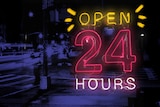 "Open 24 hours" lit up in pink and white neon lights