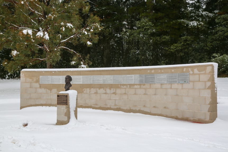 Charles Throsby memorial bust statue and wall covered with snow.