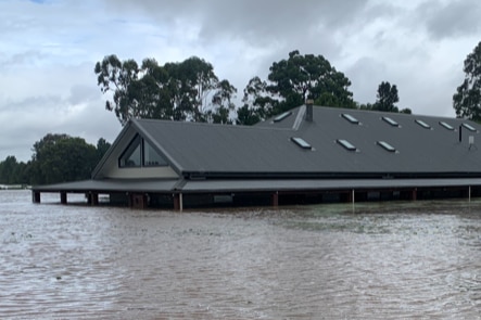 A home is flooded up to the roofline