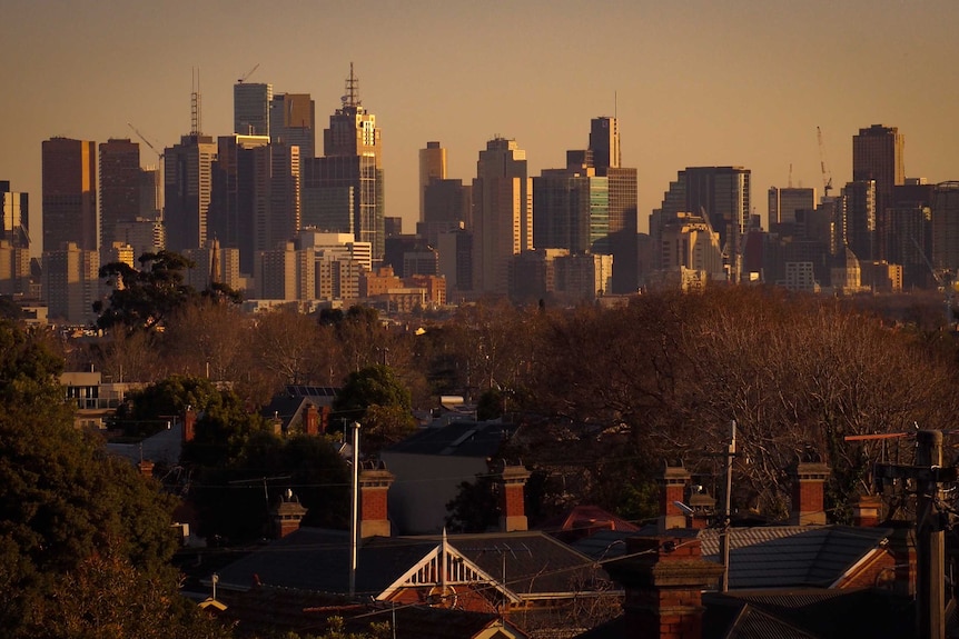 The Melbourne skyline with skyscrapers in the background and private dwellings in the foreground.