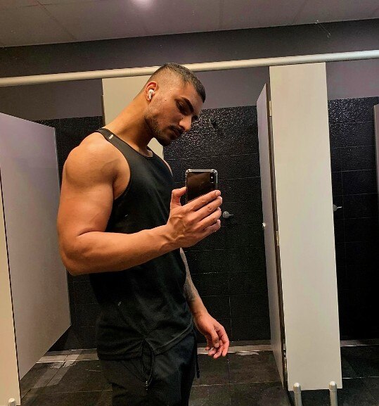 A man holding a phone takes a selfie