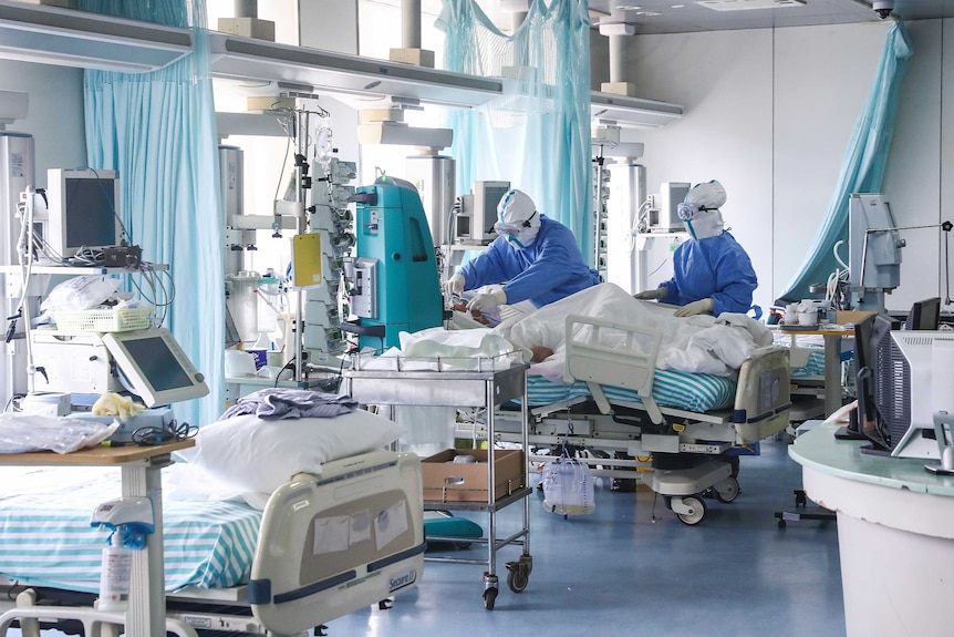 Nurses in protective suits treat a patient in the intensive care unit at Ditan Hospital in Beijing.